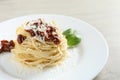 Tasty spaghetti with sun-dried tomatoes and parmesan cheese on table, closeup. Exquisite presentation of pasta dish Royalty Free Stock Photo