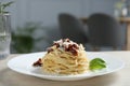 Tasty spaghetti with sun-dried tomatoes and cheese on wooden table in restaurant, closeup. Exquisite presentation of Royalty Free Stock Photo