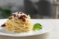 Tasty spaghetti with sun-dried tomatoes and parmesan cheese on wooden table in restaurant, closeup. Exquisite presentation of Royalty Free Stock Photo