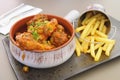 Tasty spicy rabbit stew in tomato sauce with French fries as a side dish