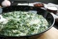 Tasty spinach dip in frying pan on table Royalty Free Stock Photo