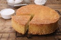 Tasty sponge cake and ingredients on wooden table, closeup Royalty Free Stock Photo