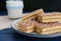 Tasty sponge cakes and milk on blue wooden table, closeup Royalty Free Stock Photo