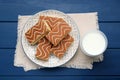 Tasty sponge cakes and milk on blue wooden table, flat lay Royalty Free Stock Photo