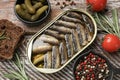 Tasty sprats in tin can served on wooden table, flat lay Royalty Free Stock Photo