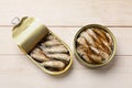 Tasty sprats in tin cans on wooden table, top view Royalty Free Stock Photo