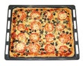 Tasty square pizza with vegetables on a baking pan