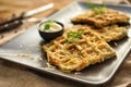 Tasty squash waffles with sauce on plate, closeup