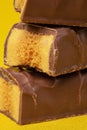 Tasty Stacked Chocolate Honeycomb Treat on yellow background