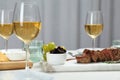 Tasty steak and glasses of white wine served