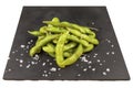 Tasty steamed edamame on a black stone plate