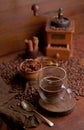 Tasty steaming espresso in cup with coffee beans. View from above. Dark background
