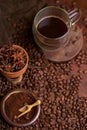 Tasty steaming espresso in cup with coffee beans. View from above. Dark background