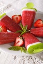 Tasty strawberry popsicle on a stick close-up. vertical