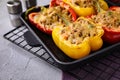 Tasty stuffed bell peppers in baking pan on grey table Royalty Free Stock Photo