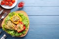 Tasty stuffed bell peppers served on blue table, flat lay. Space for text Royalty Free Stock Photo