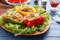 Tasty stuffed bell peppers served on blue wooden table, closeup Royalty Free Stock Photo