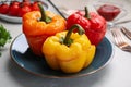 Tasty stuffed bell peppers served on grey table