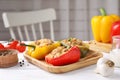 Tasty stuffed bell peppers served on wooden table in kitchen Royalty Free Stock Photo