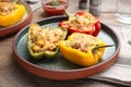 Tasty stuffed bell peppers served on wooden table Royalty Free Stock Photo