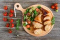 Tasty stuffed chicken legs with salad of fresh vegetables on a wooden background. Royalty Free Stock Photo