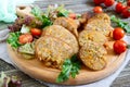 Tasty stuffed chicken legs with salad of fresh vegetables on a wooden background. Royalty Free Stock Photo