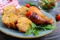 Tasty stuffed chicken legs with salad of fresh vegetables on a wooden background Royalty Free Stock Photo