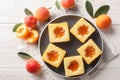 Tasty summer soft cookies Cuor di tenerezza with apricot jam close-up on a plate. Horizontal top view