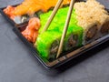 Tasty sushi bar, Eating Sushi with chopsticks. California Sushi roll set with salmon, vegetables, fish, caviar closeup. Japan Royalty Free Stock Photo