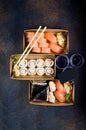 Tasty sushi rolls in disposable kraft paper boxes, sauces, chopsticks. Food for take away or delivery Royalty Free Stock Photo