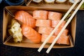 Tasty sushi rolls in disposable kraft paper boxes, sauces, chopsticks. Sushi for take away or delivery