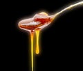 Honey in Spoon dripping isolated on black background Royalty Free Stock Photo