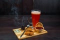 Tasty sweet hot red flavored tea with strawberry jam and oatmeal cookies stands on a wooden vintage table in a cafe. Sweet warm Royalty Free Stock Photo