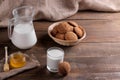 Tasty sweet oatmeal cookies with milk and honey on a brown wooden table Royalty Free Stock Photo