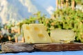 Tasty Swiss cheeses and dark pure chocolate, emmental, gruyere, appenzeller served outdoor with Alpine mountains peaks on Royalty Free Stock Photo