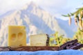 Tasty Swiss cheeses and dark pure chocolate, emmental, gruyere, appenzeller served outdoor with Alpine mountains peaks on Royalty Free Stock Photo