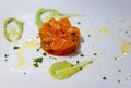 Tasty tartar from Scottish smoked salmon fish with green avocado sauce