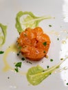 Tasty tartar from Scottish smoked salmon fish with green avocado sauce