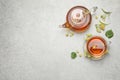 Tasty tea and linden blossom on grey table, flat lay. Space for text Royalty Free Stock Photo