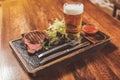 Tasty tender meat and cold lager in pub Royalty Free Stock Photo