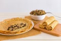 Tasty thin pancakes with fillings. Stuffed crepes with minced chicken meat mushrooms and marinated cucumber. Royalty Free Stock Photo
