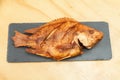 Tasty tilapia fried; photo on wooden background