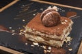 tasty tiramisu cake on slate board