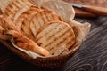 Tasty toasted bread in basket on table, closeup Royalty Free Stock Photo