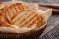 Tasty toasted bread in basket on table, closeup Royalty Free Stock Photo