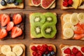 Tasty toasts with different spreads and fruits on wooden table, flat lay Royalty Free Stock Photo