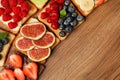 Tasty toasts with different spreads and fruits on wooden table, flat lay. Space for text Royalty Free Stock Photo