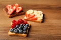 Tasty toasts with different spreads and fruits on wooden table. Space for text Royalty Free Stock Photo