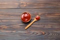 Tasty Tomato Ketchup sauce in wooden bowl with spoon on wood background. Top view with copy space Royalty Free Stock Photo