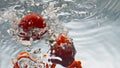 Tasty tomatoes falling water closeup. Delicious cherry veggies splashing bubbles Royalty Free Stock Photo